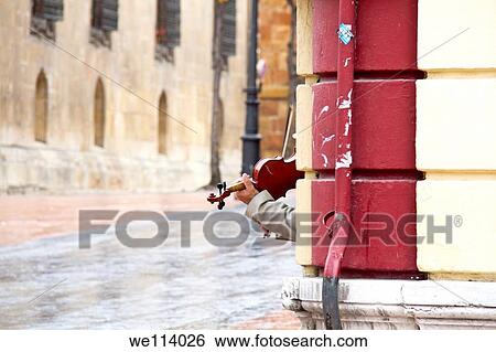 Man plays the violin on a corner in the street View Large Photo Image Stock Photograph - Man plays the violin on a corner in the street. Fotosearch