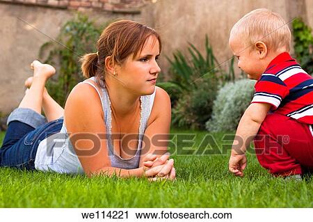 Mother with toddler serious moment in the garden View Large Photo Image Stock Image - Mother with toddler serious moment in the garden. Fotosearch