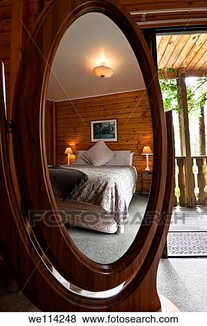 Nice warm bedroom interior of mountain lodge reflected in mirror Fox Glacier Lodge, Fox Glacier, West Coast, South Island, New Zealand View Large Photo Image Stock Photo - Nice warm bedroom interior of mountain lodge reflected in mirror Fox Glacier Lodge, Fox Glacier, West Coast, South Island, New Zealand. Fotosearch