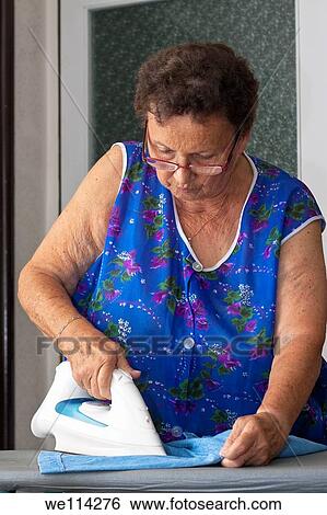 Portrait of senior woman ironing clothes View Large Photo Image Stock Photograph - Portrait of senior woman ironing clothes. Fotosearch