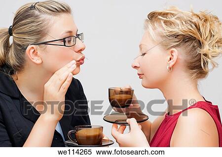 Portrait of two young women enjoying delicious cup of coffee View Large Photo Image Stock Photography - Portrait of two young women enjoying delicious cup of coffee. Fotosearch
