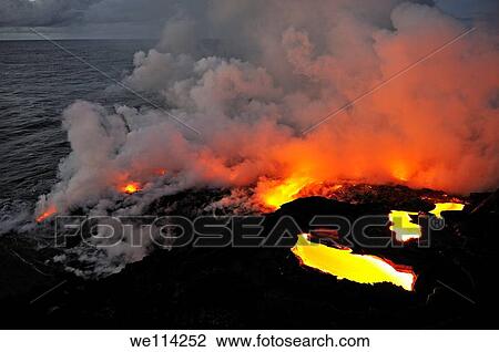 Stock Image - Steam rising off lava flowing into ocean, Kilauea Volcano, Big Island, Hawaii Islands, Usa. Fotosearch
