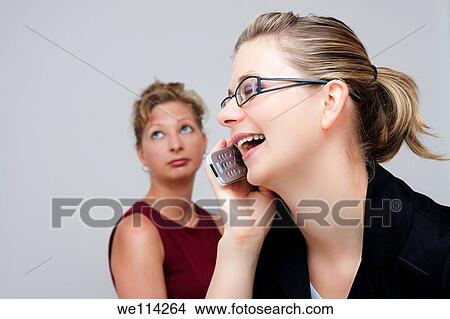 Two business women, one exited, the other one bored View Large Photo Image Picture - Two business women, one exited, the other one bored. Fotosearch