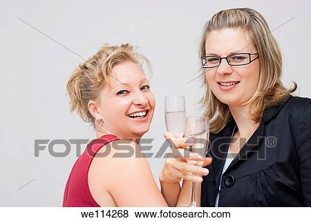 Two young business women enjoying party View Large Photo Image Stock Photo - Two young business women enjoying party. Fotosearch