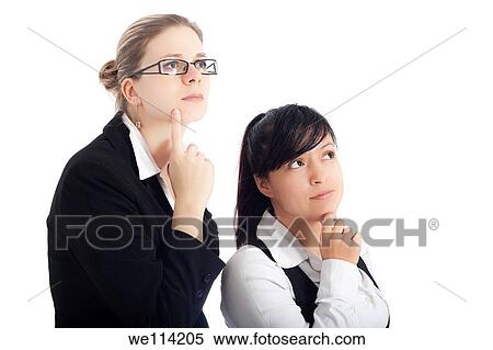 Stock Photography - Two young business women focused on new visions, isolated on white background. Fotosearch