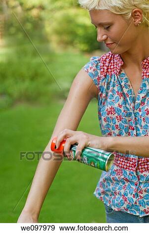 21 year old blond woman in a summer garden spraying insect repellant on her arm View Large Photo Image Stock Photo - 21 year old blond woman in a summer garden spraying insect repellant on her arm. Fotosearch