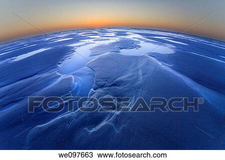 Blue planet. Wide angle shot taken from close to the ground of a wide sandy beach (northern France near Cap Blanc Nez) with some puddles during ebb. View Large Photo Image Stock Image - Blue planet. Wide angle shot taken from close to the ground of a wide sandy beach (northern France near Cap Blanc Nez) with some puddles during ebb.. Fotosearch