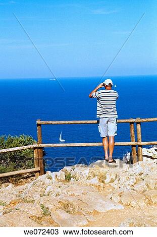 Man with binoculars at viewpoint, Cabo de la Nao. Alicante province, Comunidad Valenciana, Spain View Large Photo Image Stock Image - Man with binoculars at viewpoint, Cabo de la Nao. Alicante province, Comunidad Valenciana, Spain. Fotosearch