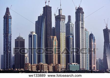 Panorama with skyscrapers, different levels of buildings and ambitious construction works, Dubai, United Arab Emirates. View Large Photo Image Stock Photo - Panorama with skyscrapers, different levels of buildings and ambitious construction works, Dubai, United Arab Emirates.. Fotosearch