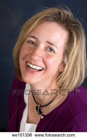 A fair skinned woman with short blond hair smiles and laughs as she looks at the camera. View Large Photo Image Stock Photograph - A fair skinned woman with short blond hair smiles and laughs as she looks at the camera.. Fotosearch