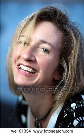 Big smile on an attractive woman with shoulder length blond hair. View Large Photo Image Picture - Big smile on an attractive woman with shoulder length blond hair.. Fotosearch