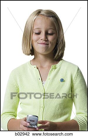 A young girl sending a text message View Large Photo Image Stock Image - A young girl sending a text message. Fotosearch