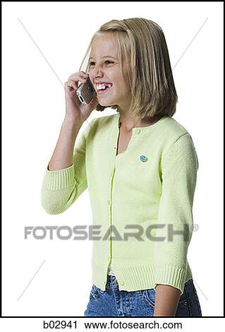 Stock Image - A young girl talking on a mobile phone. Fotosearch