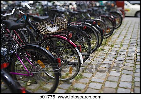 Bicycles parked in a row View Large Photo Image Stock Photography - Bicycles parked in a row. Fotosearch