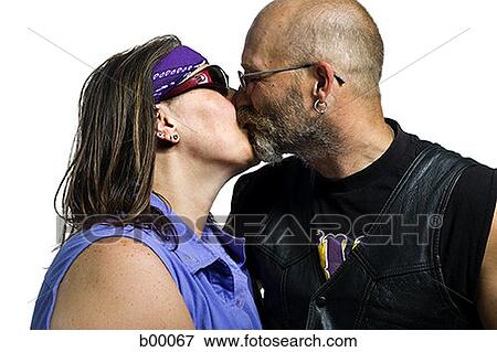 Biker couple kissing each other View Large Photo Image Stock Photo - Biker couple kissing each other. Fotosearch