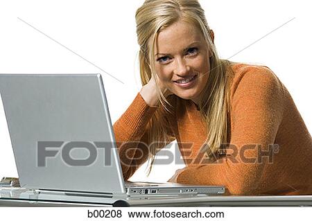 Blonde woman using a laptop computer View Large Photo Image Stock Photo - Blonde woman using a laptop computer. Fotosearch