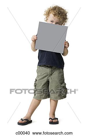 Boy holding a blank sign in front of his face View Large Photo Image Stock Image - Boy holding a blank sign in front of his face. Fotosearch