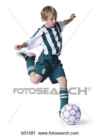 Boy kicking a soccer ball View Large Photo Image Stock Image - Boy kicking a soccer ball. Fotosearch