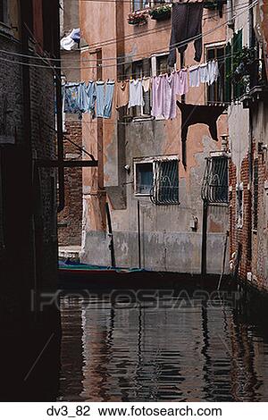 Stock Image - Buildings on the both side of a canal, Venice, Italy. Fotosearch