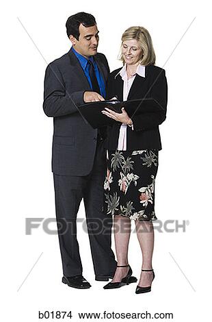 Businessman and a businesswoman looking over paperwork View Large Photo Image Picture - Businessman and a businesswoman looking over paperwork. Fotosearch
