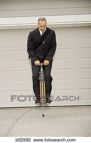 Businessman on a pogo stick View Large Photo Image Stock Image - Businessman on a pogo stick. Fotosearch