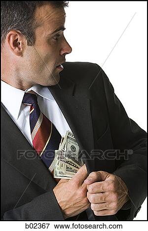 Stock Photo - Businessman putting money in his jacket. Fotosearch