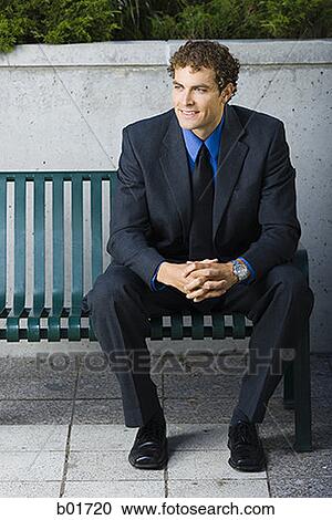 Businessman sitting on a bench View Large Photo Image Stock Image - Businessman sitting on a bench. Fotosearch