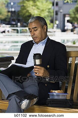 Businessman sitting on a bench with a flask View Large Photo Image Stock Image - Businessman sitting on a bench with a flask. Fotosearch