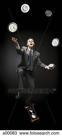Businessman standing on hourglass, juggling clocks View Large Photo Image Stock Image - Businessman standing on hourglass, juggling clocks. Fotosearch