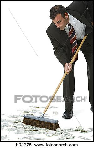 Businessman sweeping money on the floor View Large Photo Image Stock Photography - Businessman sweeping money on the floor. Fotosearch