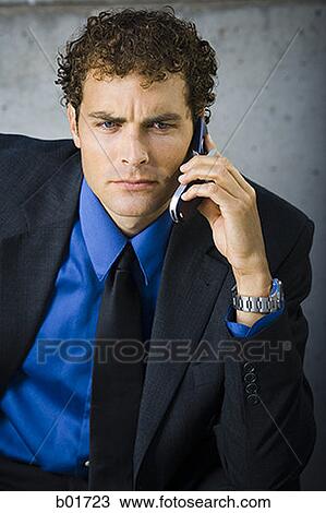 Businessman talking on a mobile phone View Large Photo Image Stock Image - Businessman talking on a mobile phone. Fotosearch
