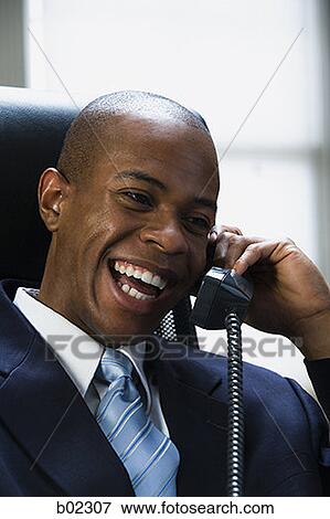 Businessman talking on the telephone View Large Photo Image Stock Photo - Businessman talking on the telephone. Fotosearch