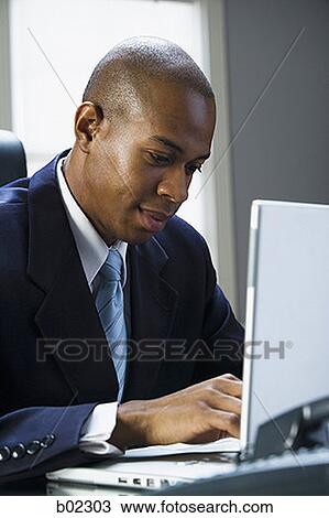 Businessman working on a laptop computer View Large Photo Image Stock Image - Businessman working on a laptop computer. Fotosearch