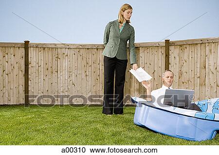 Businesswoman handing papers to a businessman in a wading pool View Large Photo Image Stock Image - Businesswoman handing papers to a businessman in a wading pool. Fotosearch