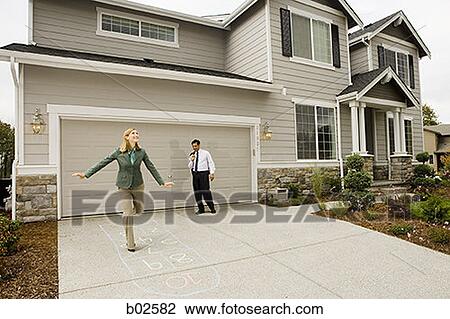 Businesswoman playing hopscotch with a businessman standing behind her View Large Photo Image Stock Image - Businesswoman playing hopscotch with a businessman standing behind her. Fotosearch