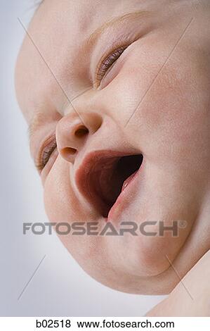 Stock Photo - Close-up of a baby girl crying. Fotosearch