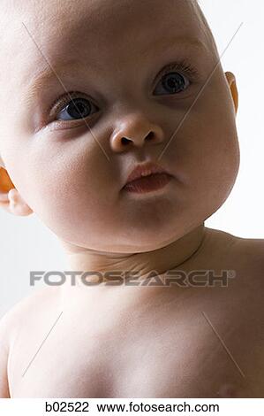 Close-up of a baby girl looking away View Large Photo Image Stock Image - Close-up of a baby girl looking away. Fotosearch