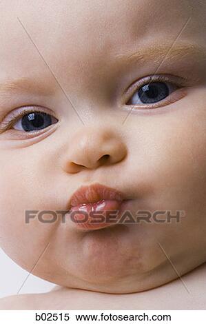 Close-up of a baby girl puckering her lips View Large Photo Image Stock Photography - Close-up of a baby girl puckering her lips. Fotosearch