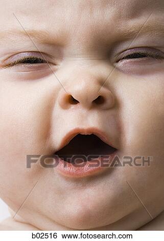 Close-up of a baby girl yawning View Large Photo Image Stock Photograph - Close-up of a baby girl yawning. Fotosearch