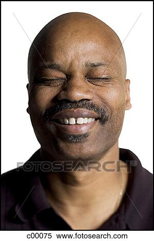 Stock Photography - Close-up of a Black man smiling, eyes closed. Fotosearch