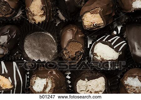 Stock Photo - Close-up of a box of half eaten chocolates. Fotosearch