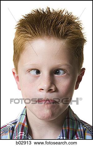 Stock Image - Close-up of a boy crossing his eyes. Fotosearch