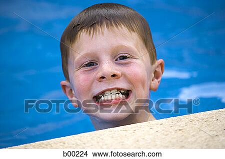 Close-up of a boy with exaggerated smile, in swimming pool View Large Photo Image Picture - Close-up of a boy with exaggerated smile, in swimming pool. Fotosearch