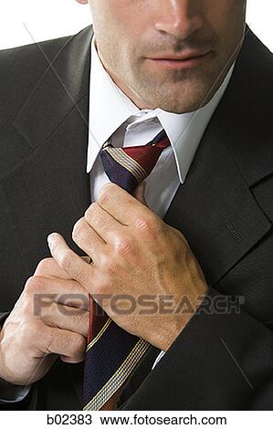 Close-up of a businessman adjusting his tie View Large Photo Image Stock Image - Close-up of a businessman adjusting his tie. Fotosearch