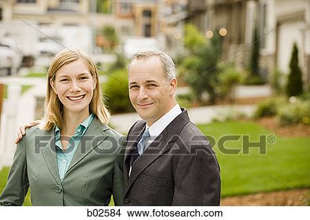 Close-up of a businessman and a businesswoman standing View Large Photo Image Picture - Close-up of a businessman and a businesswoman standing. Fotosearch