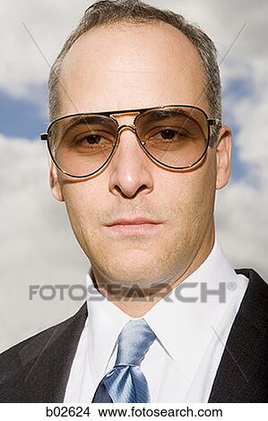 Close-up of a businessman looking at the camera View Large Photo Image Picture - Close-up of a businessman looking at the camera. Fotosearch