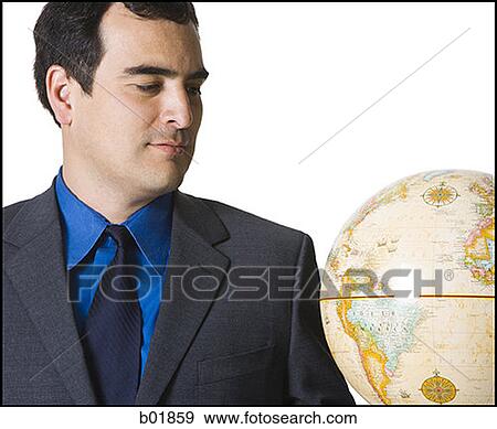 Close-up of a businessman looking at the globe View Large Photo Image Stock Photo - Close-up of a businessman looking at the globe. Fotosearch