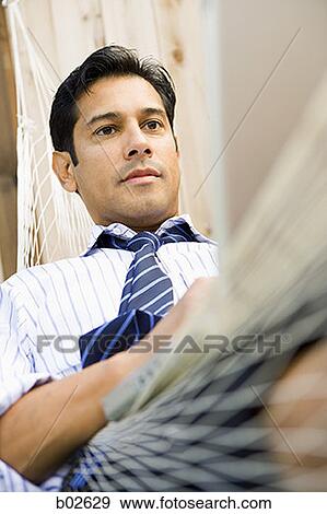 Close-up of a businessman sitting in a hammock View Large Photo Image Stock Photo - Close-up of a businessman sitting in a hammock. Fotosearch