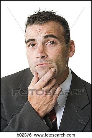 Close-up of a businessman thinking View Large Photo Image Stock Photograph - Close-up of a businessman thinking. Fotosearch