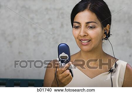 Close-up of a businesswoman looking at a mobile phone View Large Photo Image Stock Image - Close-up of a businesswoman looking at a mobile phone. Fotosearch